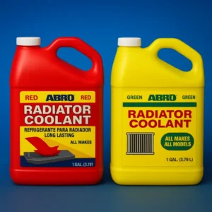 Deux bouteilles de liquide de refroidissement ABRO, une rouge et une jaune, sont placées côte à côte. La bouteille rouge, étiquetée "RED RADIATOR COOLANT", porte la mention "REFRIGERANTE PARA RADIADOR LONG LASTING" et "ALL MAKES". Elle contient 1 gallon (3,781 L). La bouteille jaune, étiquetée "GREEN RADIATOR COOLANT", est également pour "ALL MAKES ALL MODELS" et contient 1 gallon (3,79 L). Un petit symbole de radiateur est visible sur l'étiquette jaune.